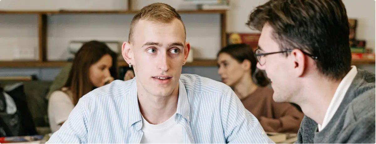 Two people talking in a supportive setting, representing dual diagnosis care for co-occurring mental health and substance use disorders.