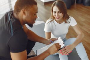 Athlete reviewing recovery plan with coach during performance-focused detox program