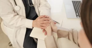 Therapist offering compassionate support to a patient during trauma-informed therapy for addiction recovery